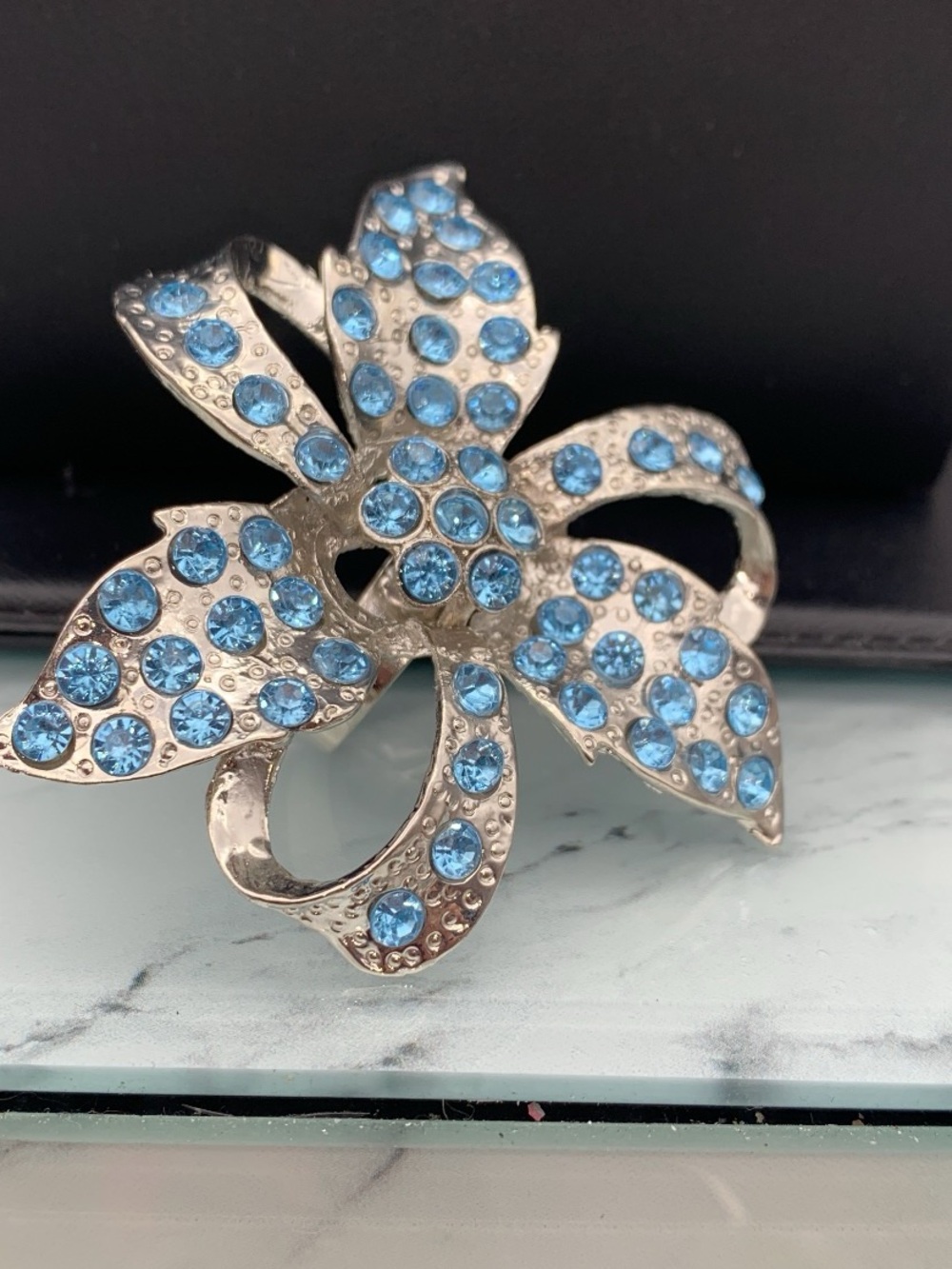 Silver tone large Flower Brooch look ring with Blue Crystals size adj. 8.75